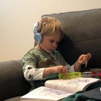 boy sitting on couch connected to neurOptimal home system